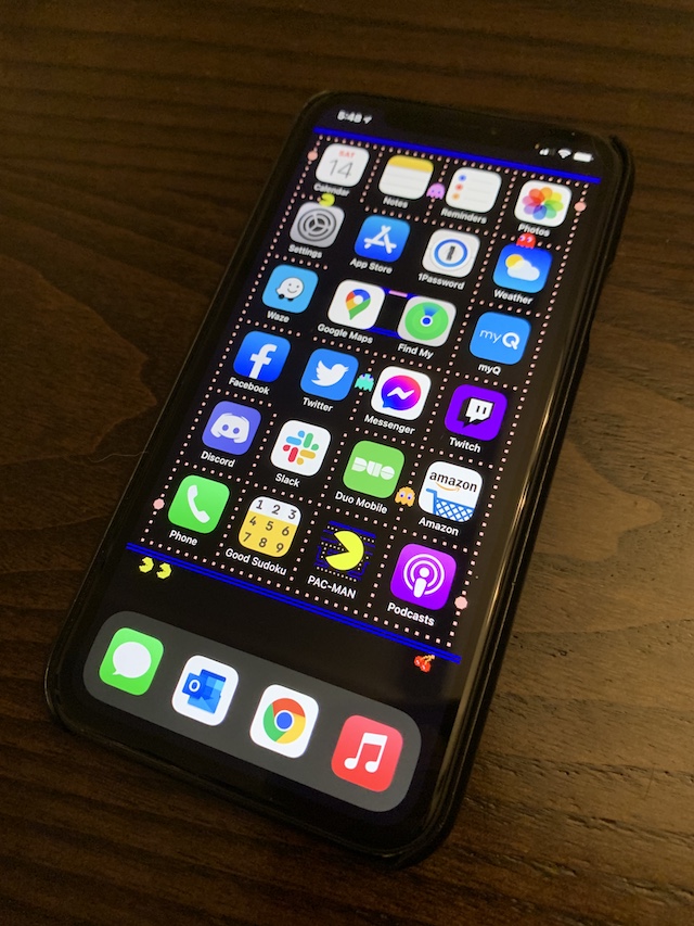 Photo of my iPhone XR with the Pac-Man wallpaper